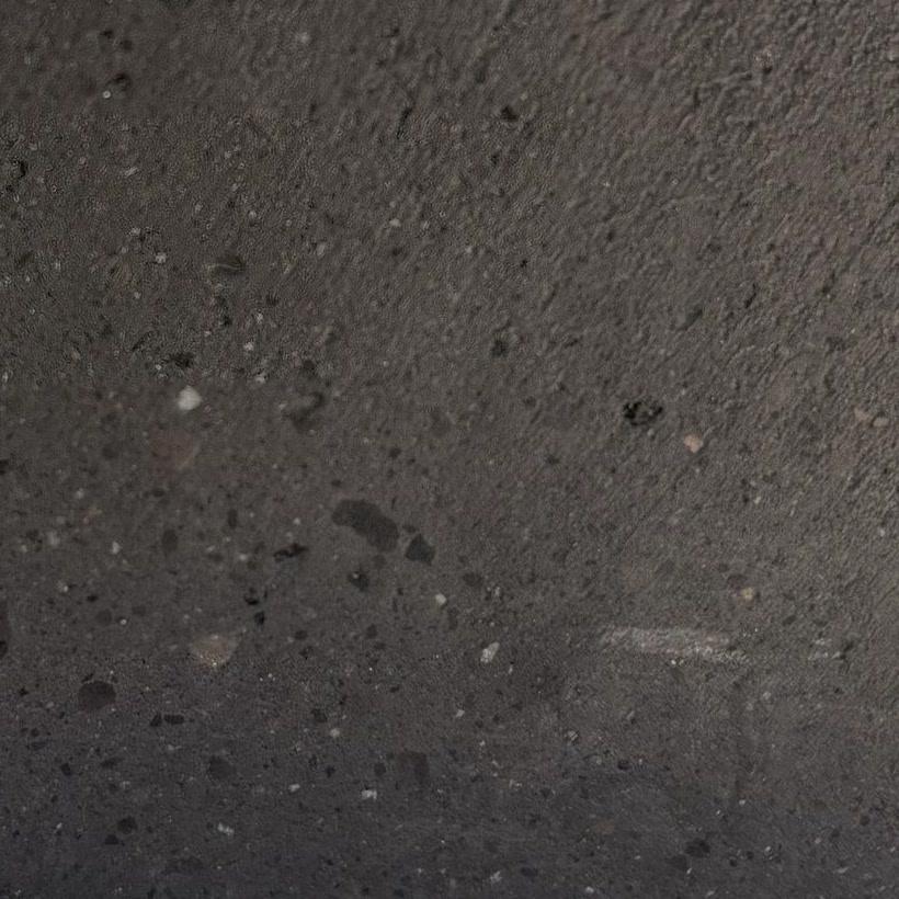 Close-up of a basalt surface with fine pores and small inclusions