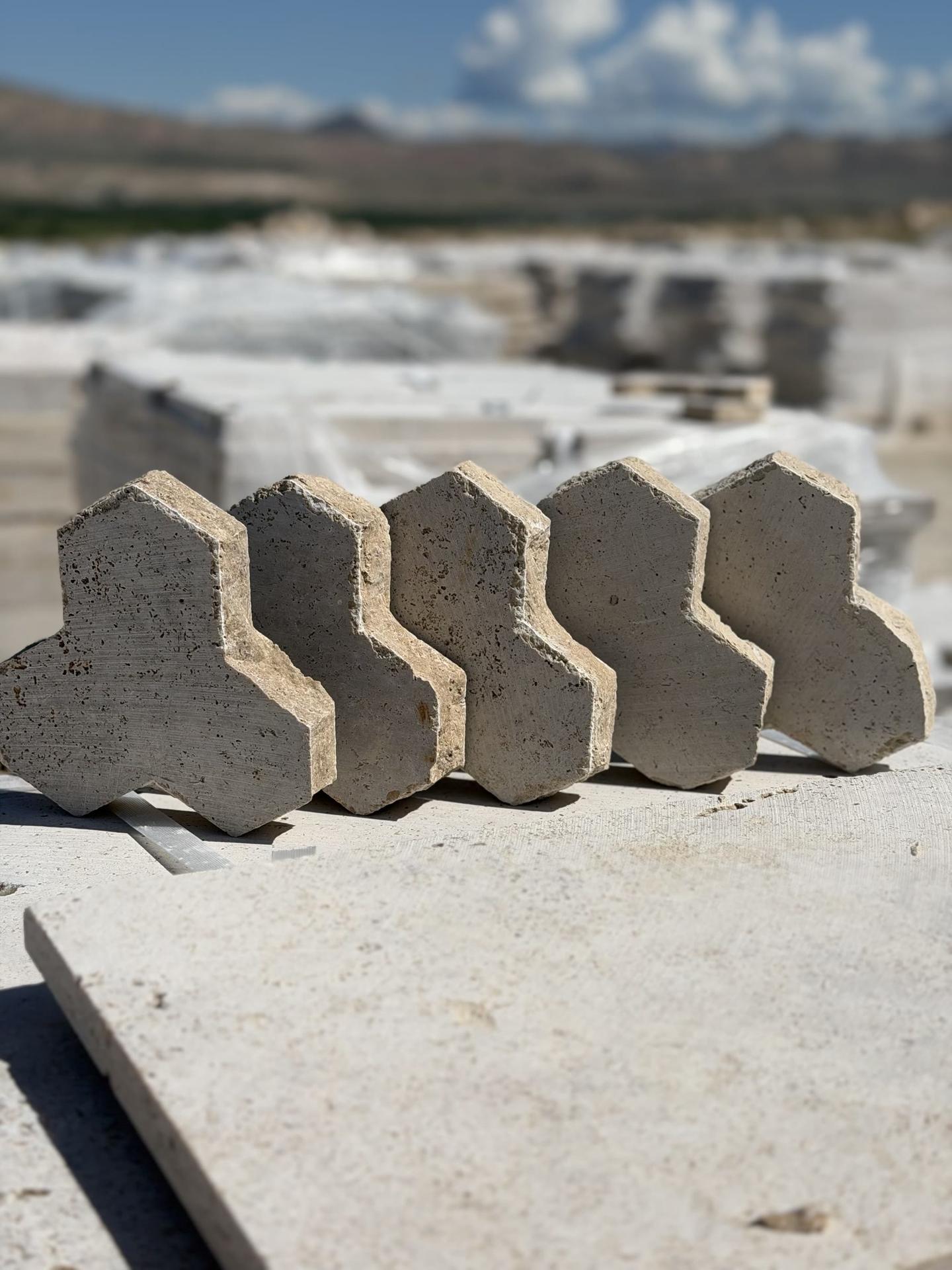 Interlocking travertine pavers cut to a curved profile
