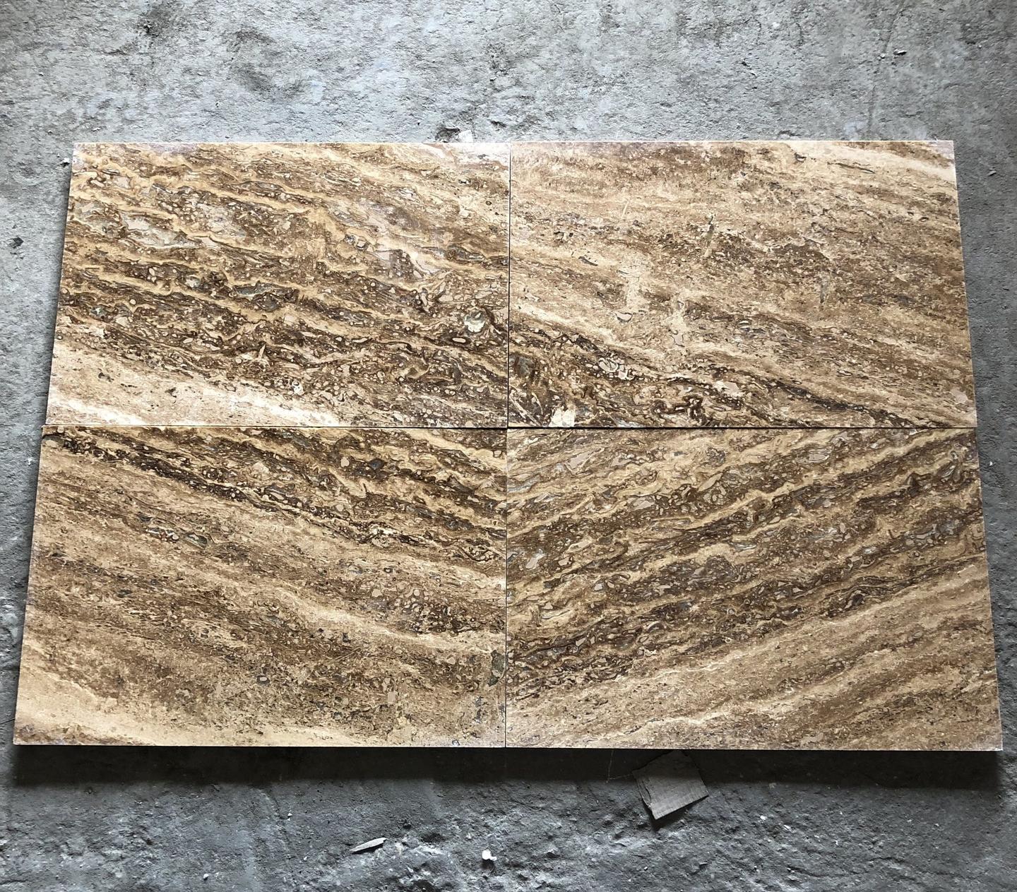 Four vein-cut travertine tiles laid edge to edge