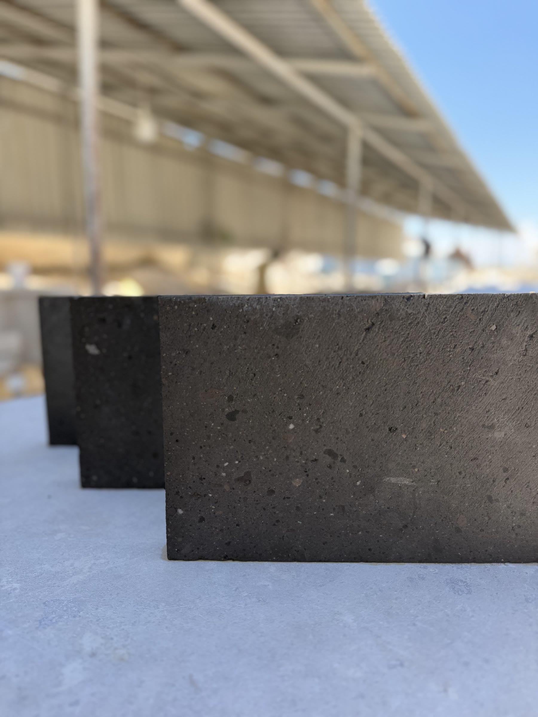 Basalt tiles standing in a row under the workshop canopy