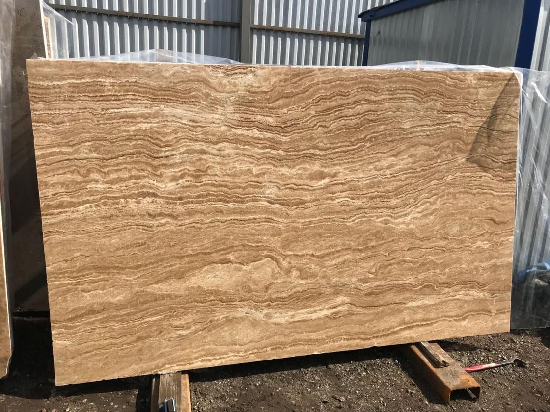 Vein-cut travertine slab with fine parallel banding