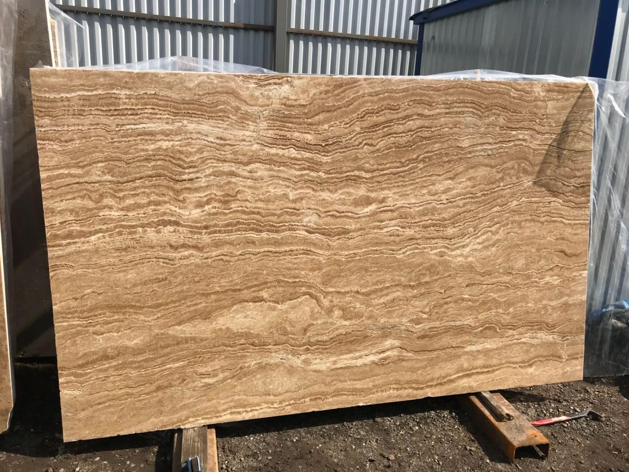 Vein-cut travertine slab with fine parallel banding